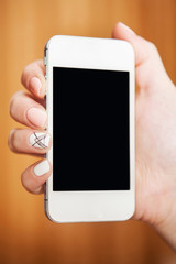 Woman holds in hand wite smartphone