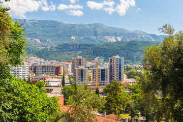 Obraz premium Cityscape of Budva city surrounded by mountains on Adriatic sea coastline at Montenegro. view from above