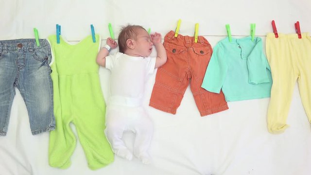 Newborn and baby clothes on a string, funny clean and dry