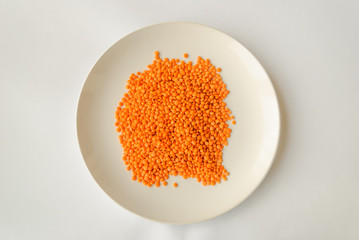 red lentils on a white background