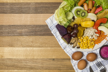 Salads ,eggs and milk placed on wooden table