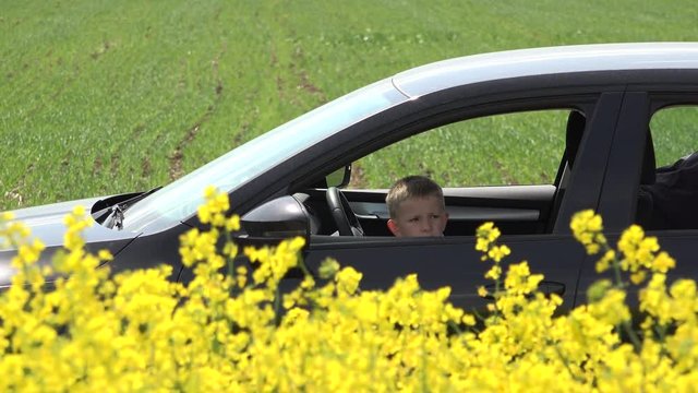 Funny child pretend to drive and call passengers, car in rape field