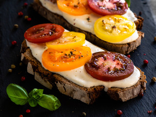 rye bread with cream cheese and color tomatoes