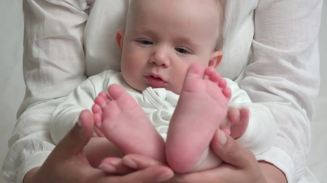 Detail of mothers arms holding innocent baby, it can not be better