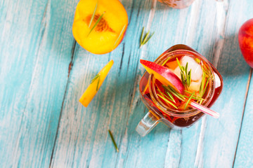 peach ice tea fresh mint rosemary wooden background
