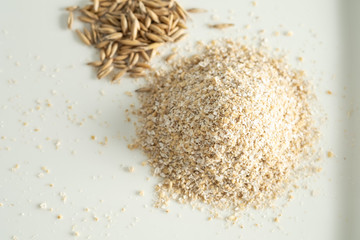 Bran oatmeal coarse, useful, cleansing, for healthy eating on a white background