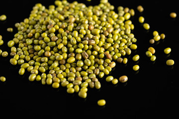 dry beans, mung beans, on a black background