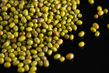 dry beans, mung beans, on a black background