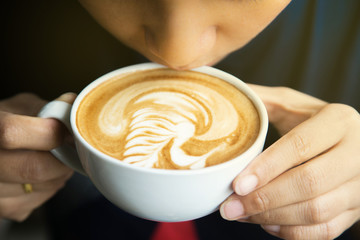 People drinking hot coffee, art latte coffee.