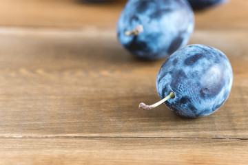 Plum Fresh Plum Harvest Autumn harvest Blue plums Fresh Plums on a Wooden Background Copy Space
