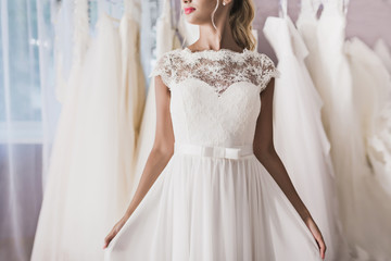 Attractive woman wearing dress in wedding salon no face