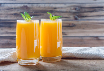 Healthy pumpkin fruit smoothie with  mint leaves on  table.