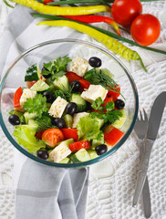 Salad of fresh vegetables and cheese on  served table