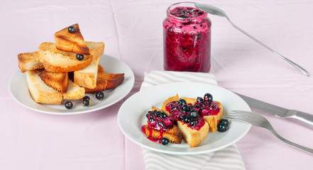 Delicious toasts bread with homemade currant jam with fork and knife