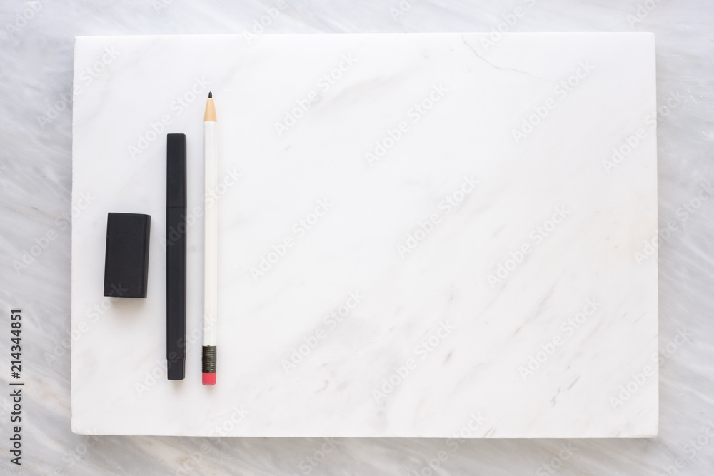 Poster Top view of Clip blackboard, pencil, eraser on white marble block and stack on grey marble table.Flat lay Mock up template for adding or display text or design. Stationery item.