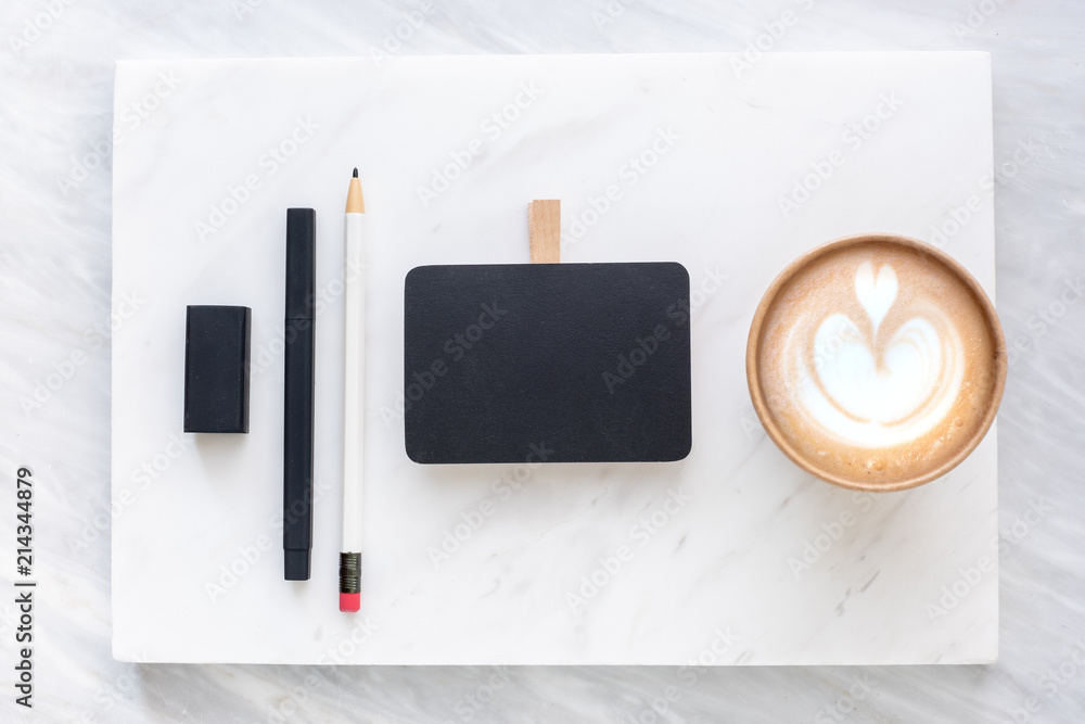 Poster Top view of Clip blackboard, pencil, eraser pine leaf and coffee cup on white marble block and stack on grey marble table.Flat lay Mock up template for adding or display text or design