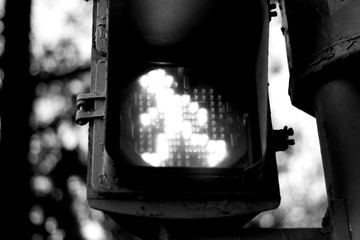 Traffic light in green to indicate crossing the road to pedestrians