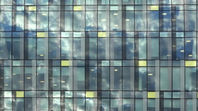 Clouds passing reflected in the glass of modern building