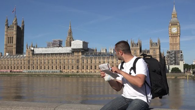 Tourist plans the city visit on London map