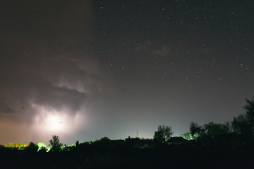 Night summer thunderstorm in the countryside. Night landscape