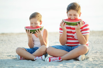 The boy is eating watermelon
