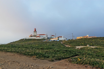 Fototapeta na wymiar Panoramic view of the westernmost point in Europe. Cape Roca lighthouse. The edge of the land. Cabo da Roca, Portugal.