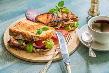 Rustic fast breakfast - toasted toasts with tomatoes and cheese, fruit tea