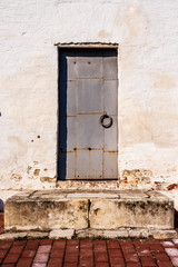 Old pattern - vintage metal door on the old plaster walls
