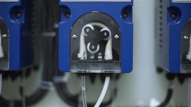 the worker of the plant starts a peristaltic pump for feeding acid and alkali