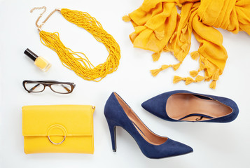 Bright yellow accessories and blue shoes for girls and women. Urban fashion, beauty blog concept