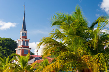 Petite Anse d'Arlet village in Martinique, with Saint Henri Church and palm trees