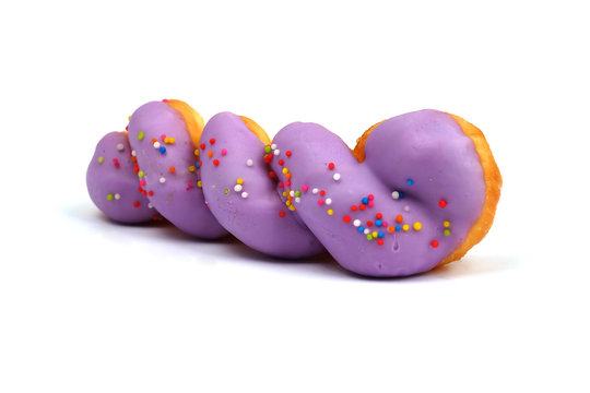 Isolated picture of spiral doughnut with sweet cream topping and colorful sugar bead, popular dessert for kids and teenager that cause overweight problem lead to heart disease because of dangerous fat