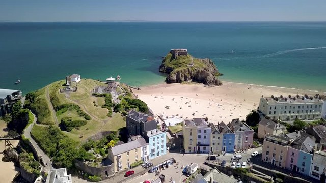 Aerial drone view of the historic Welsh seaside town of Tenby and its twin sandy beaches and medieval fort
