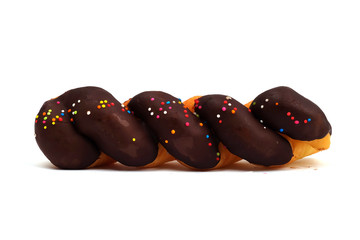 twist Doughnut with glaze Chocolate and colorful sprinkles isolated on white background.