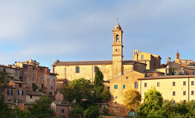 Fototapeta na wymiar Italy. Tuscany. View on the medieval town of Montepulciano and the bell tower of S. Agostino Church at sunny September morning