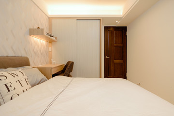 Modern and cosy design of the bedroom in apartment building