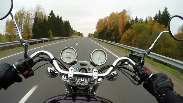 4K. Fast motorcycle riding on the beautiful forested road, wide point of view of rider. Classic cruiser/chopper forever! 