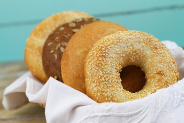 Selection of white and brown bagels in bread basket, closeup
