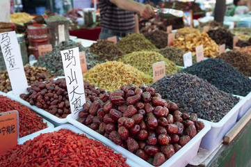 Fototapeta na wymiar Dried fruirs being sold in a market stall at a street market in the city of Dunhuang, in China
