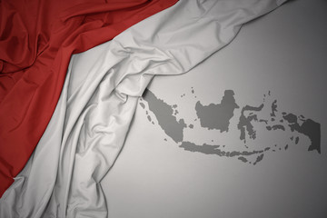 waving colorful national flag and map of indonesia. - obrazy, fototapety, plakaty