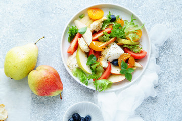 Original panzanella salad with mozarella, toasted baguette, tomatoes and plums on rustic background. Summer cuisine concept. Top view