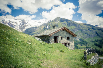 Fototapeta na wymiar Alpine chalet in alpine valley of Gressoney Monte Rosa