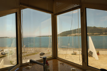 Image of river and spanish coast through the window of house at the portuguese land