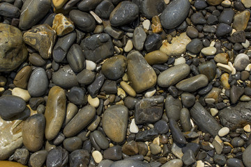 Coastal crude sea pebbles. Texture.