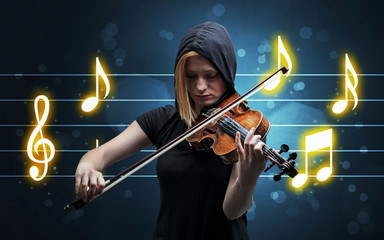 Fototapeta premium Young handsome fiddler playing with music sheet background