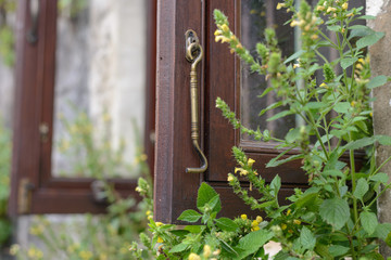 close up of vintage brass window hook for lock window when it open