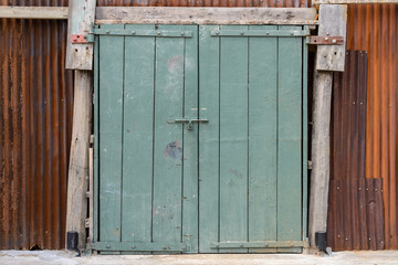 Obraz na płótnie Canvas Old wooden gate with rusty zinc wal