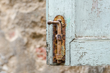 Rust locked bolt with old wooden window