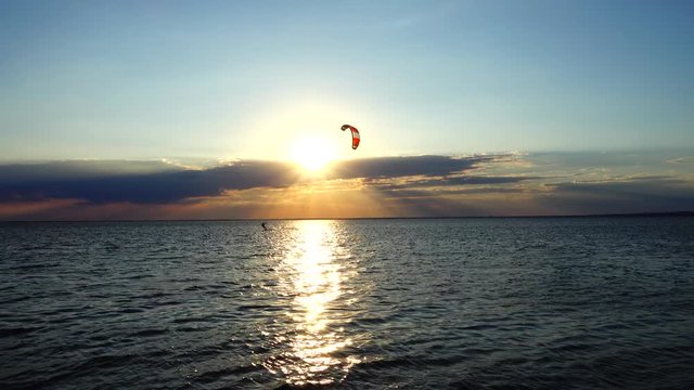 Kite boarding.	Sunset over the sea. Sport.
