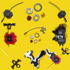 set of beyblade kid toys over yellow background. Ring, handle, launcher, gyroscope. Instagram template